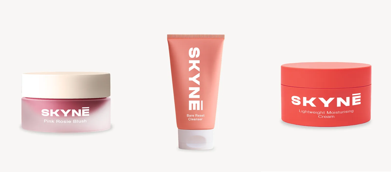 Three AI-generated SKYNE products side by side: a pink blush pot, a coral cleanser tube and a red moisturiser jar.